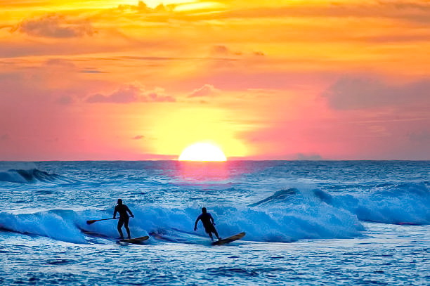 California Flats LLC of Ventura County Beach sunset with surfer and wader over the ocean wave